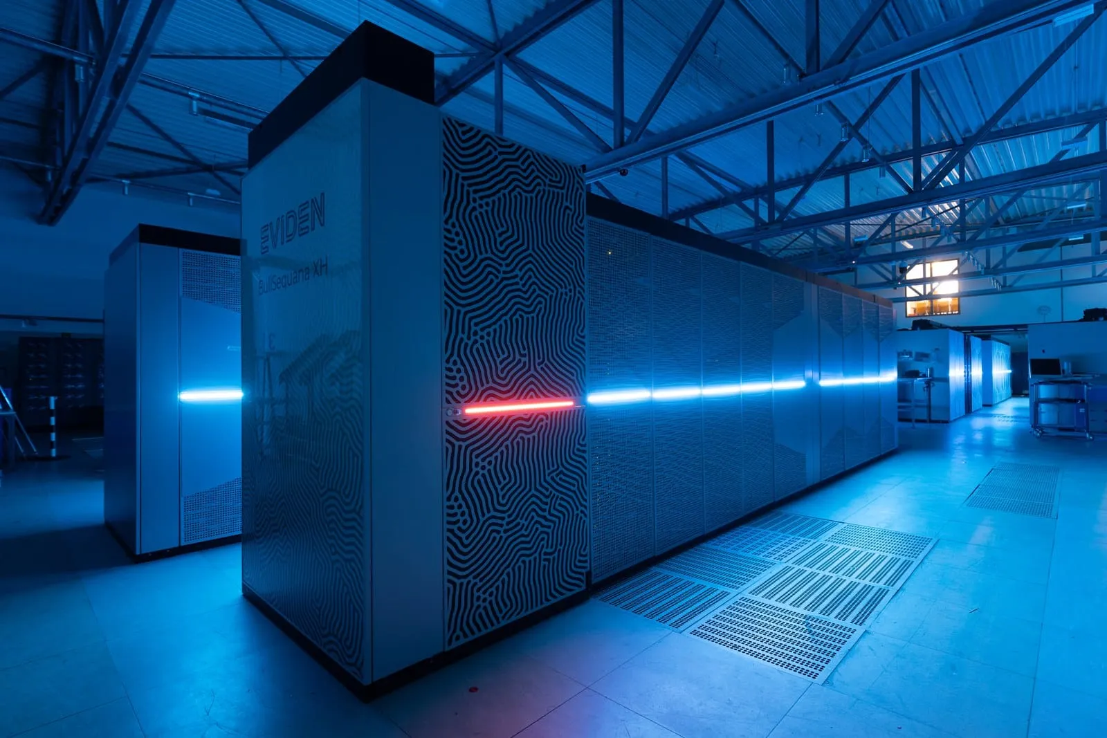 Eviden supercomputer racks in a blue-lit data centre hall at Jülich